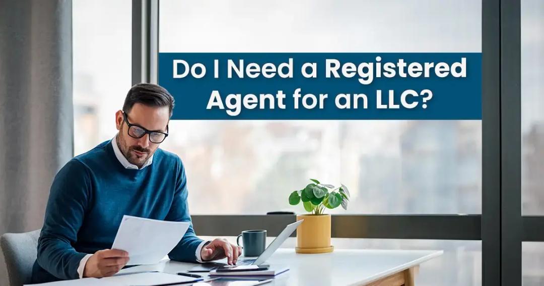 Man reading documents at a desk with a laptop and a plant beside him, under a sign asking "do i need a registered agent for an llc?.