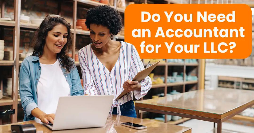 Two women are discussing something on a laptop. One holds a clipboard. Text in the image reads, "Do You Need an Accountant for Your LLC?" Shelves with items are visible in the background.