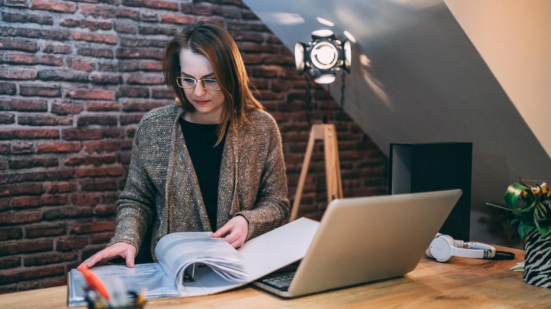 Woman reviewing a guide of financial resources for small businesses during the COVID-19 pandemic
