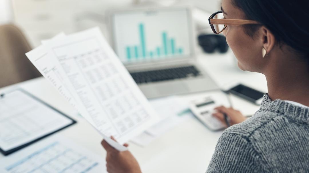Woman looking at spreadsheets for hiring a tax professional